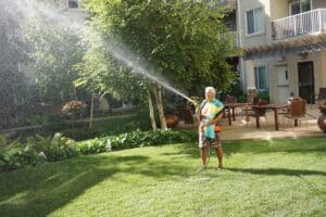 senior man watering the lawn