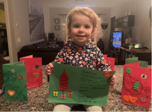 Tips for Helping a Senior Cope With Holiday Loneliness - All Seniors Care child with cards