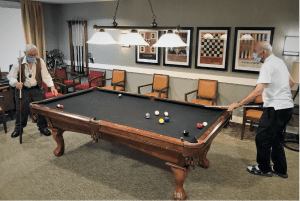 How to Get Seniors Motivated This Winter: Spirited Week - All Seniors Care Residents playing pool